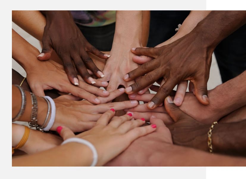 A group of people with their hands together.