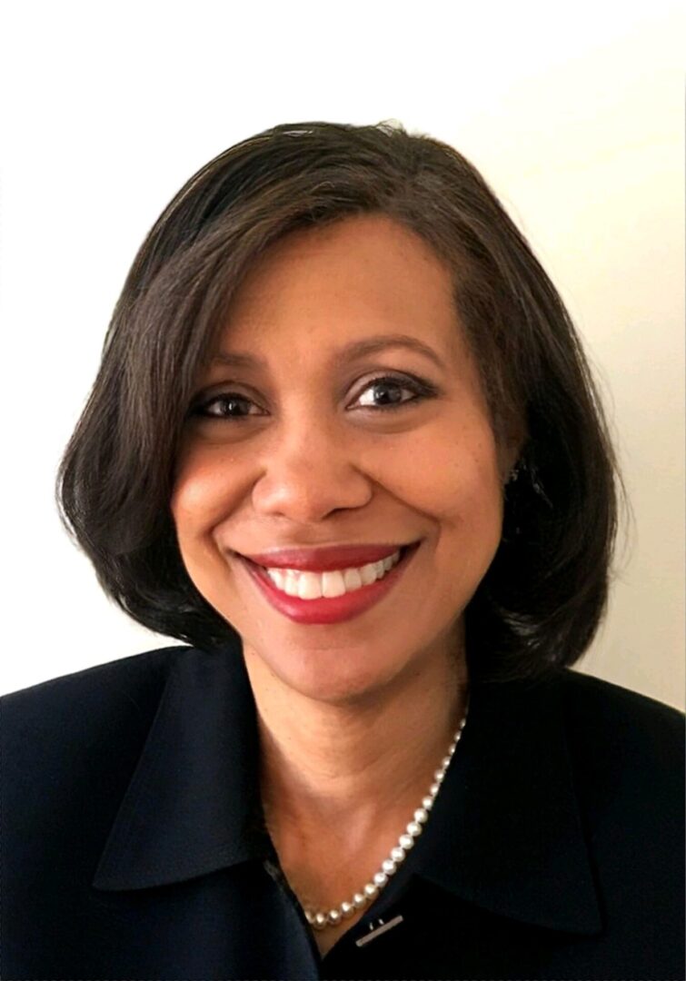 A woman with short hair smiles for the camera.